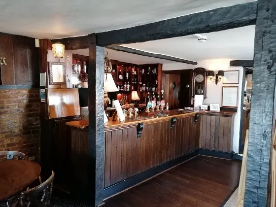 Inside the bar area, looking through to the fireplace.